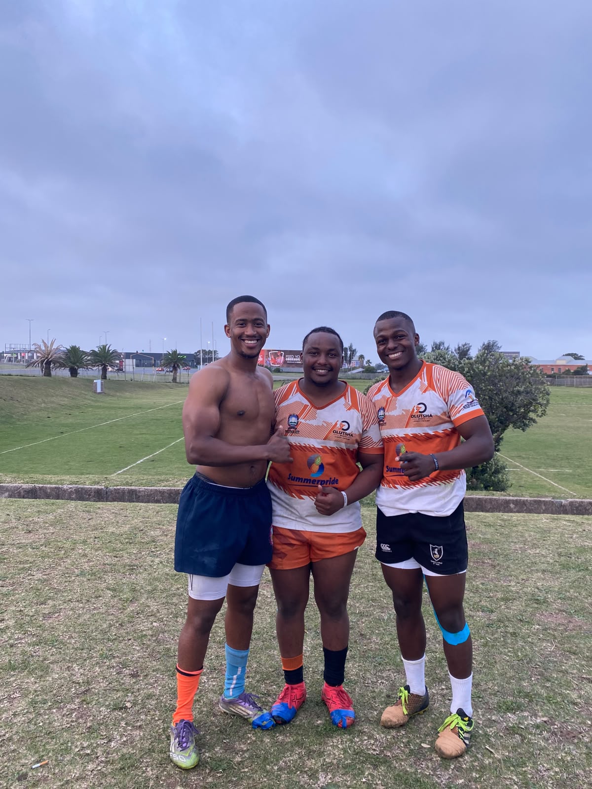 Three Olutsha Wolves players in the 2026 Summerpride kit after a match