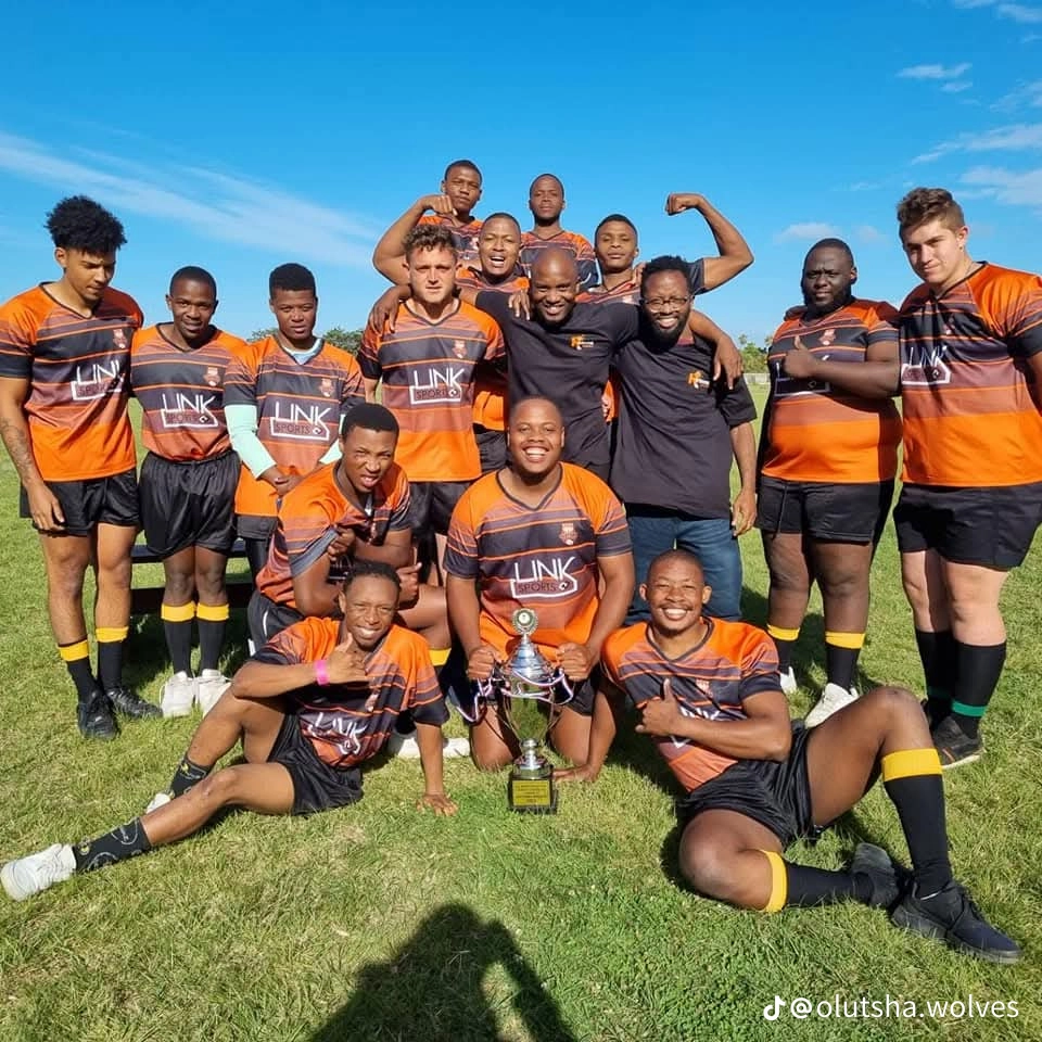 Olutsha Wolves squad celebrating with the 2021 championship trophy