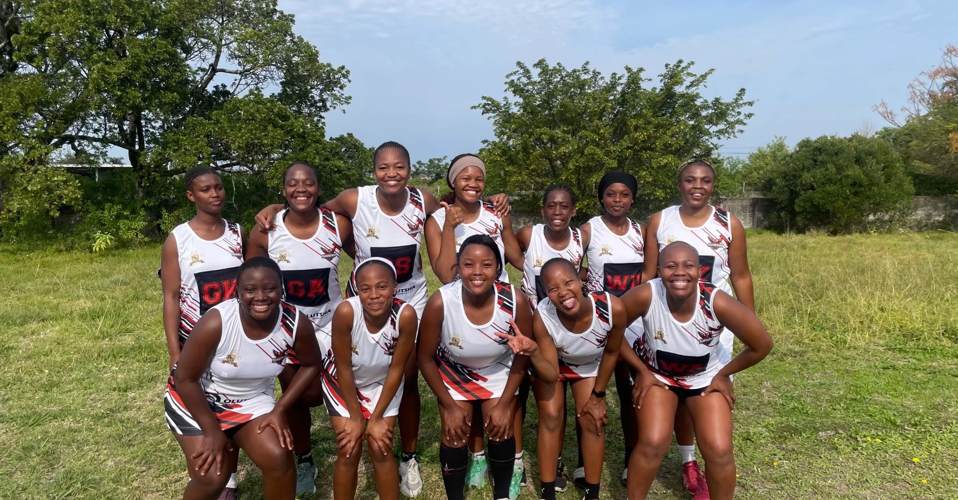 Olutsha Sunbirds Netball Club squad photograph on the field